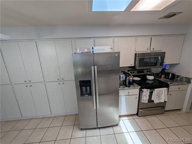 kitchen with appliances with stainless steel finishes and light tile patterned floors