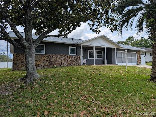 ranch-style home featuring an attached garage, stone siding, stucco siding, and concrete driveway