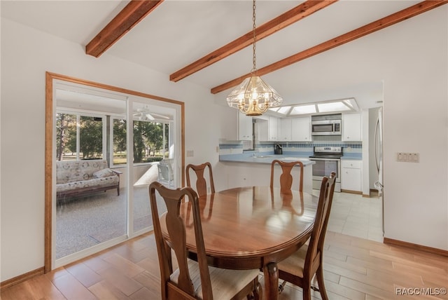 dining space with a chandelier and beamed ceiling