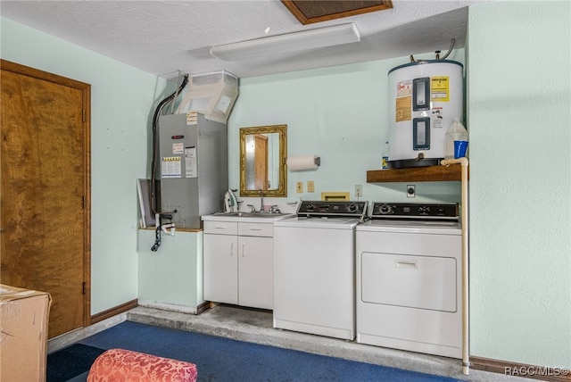 laundry room with a textured ceiling, sink, washer and dryer, cabinets, and electric water heater