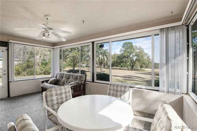 sunroom / solarium featuring ceiling fan and plenty of natural light