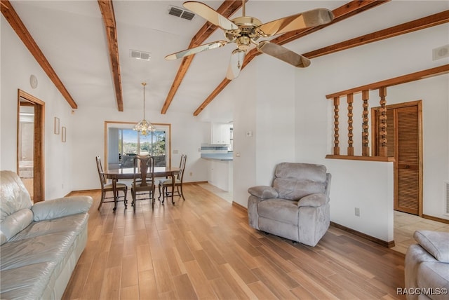 living room with ceiling fan with notable chandelier, light hardwood / wood-style flooring, and vaulted ceiling with beams