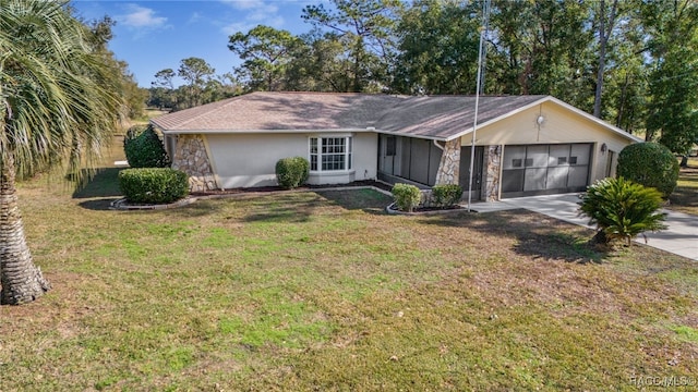 single story home featuring a front yard and a garage