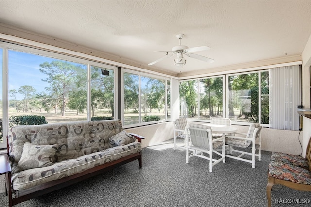 sunroom featuring ceiling fan