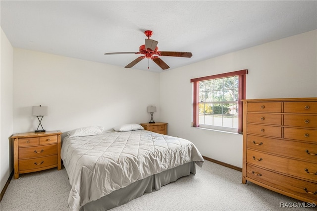 bedroom with ceiling fan and light colored carpet