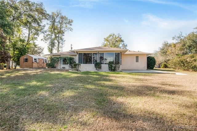 view of front of house featuring a front yard and a shed