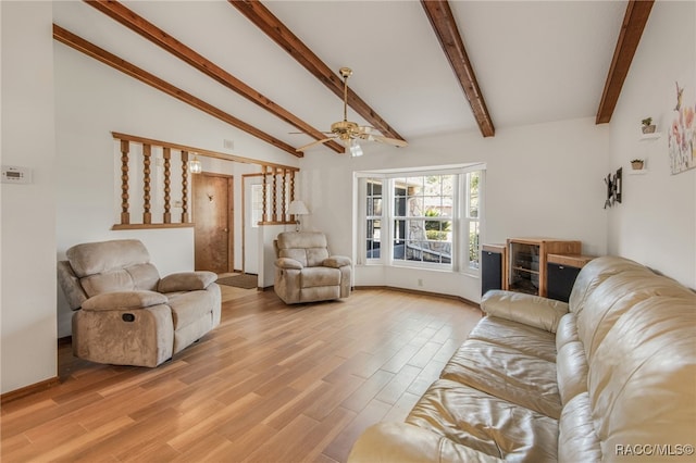 living room with ceiling fan, light hardwood / wood-style flooring, and vaulted ceiling with beams