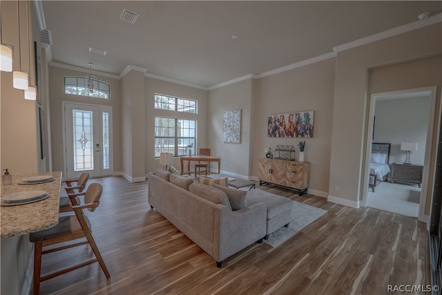 living room featuring wood-type flooring and ornamental molding