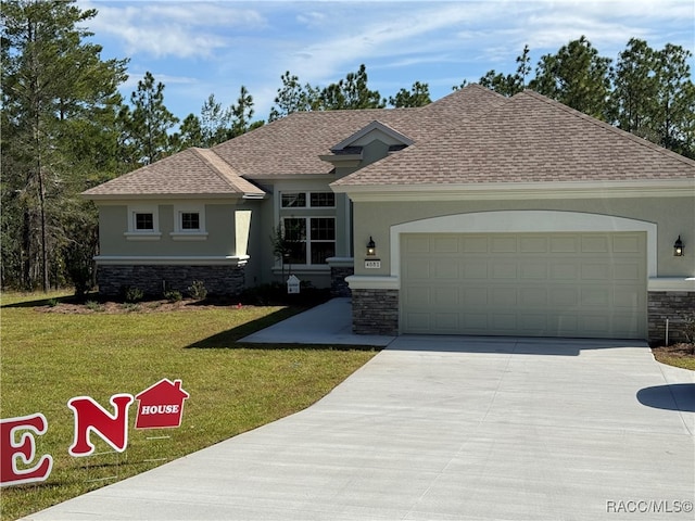 view of front of property with a front yard and a garage