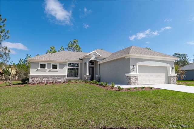 view of front of home with a front lawn and a garage