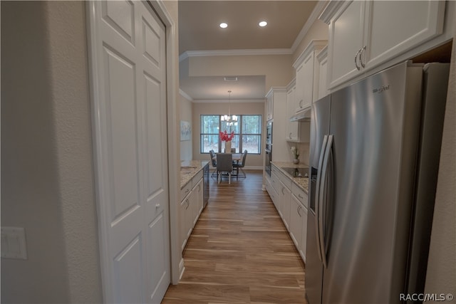 kitchen with white cabinets, light hardwood / wood-style flooring, stainless steel fridge, ornamental molding, and light stone counters