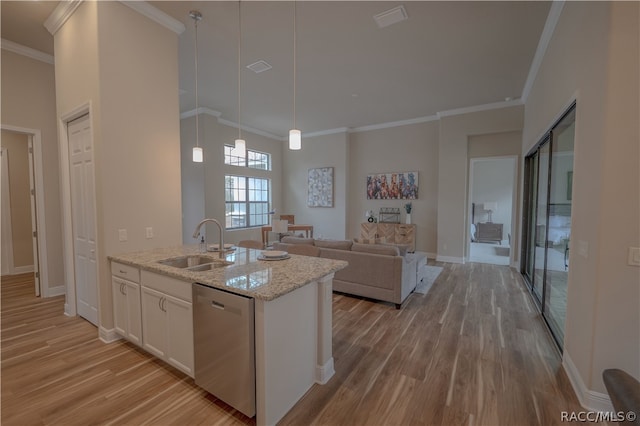 kitchen featuring sink, light hardwood / wood-style flooring, stainless steel dishwasher, light stone counters, and white cabinetry