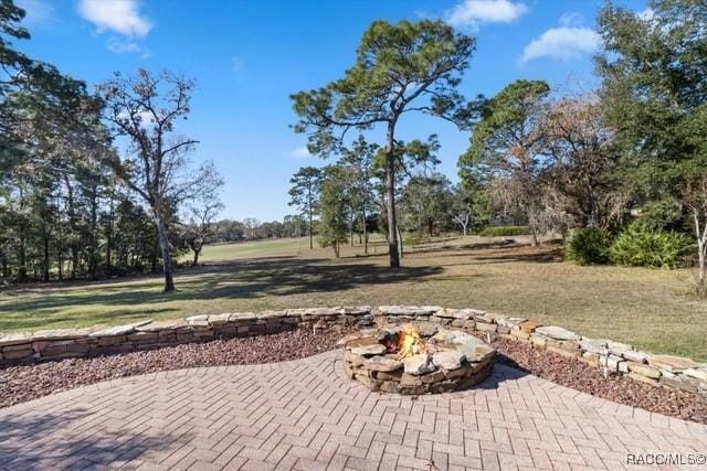 view of patio with a fire pit