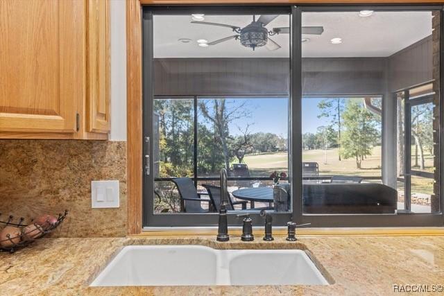 interior space featuring backsplash and ceiling fan