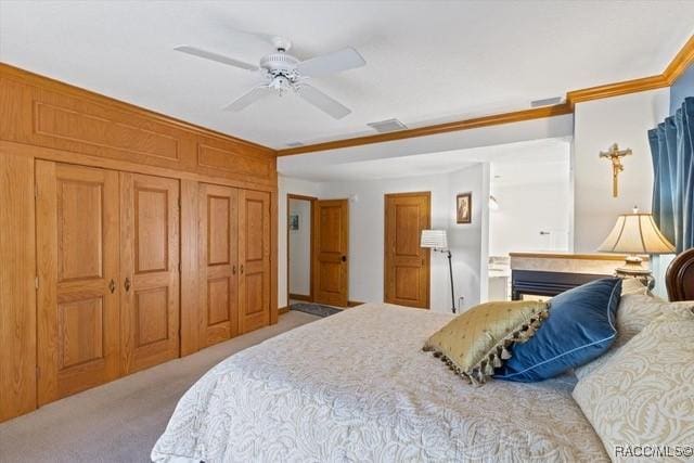 bedroom with crown molding, ceiling fan, and light colored carpet