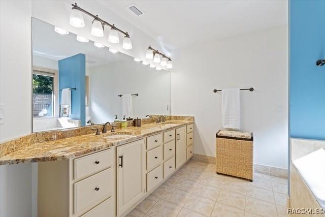 bathroom with vanity and tile patterned flooring