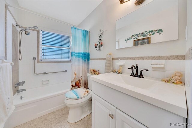 66 S Desoto St, Beverly Hills, FL 34465 - bathroom featuring speckled floor, vanity, shower / tub combo, tile walls, and toilet