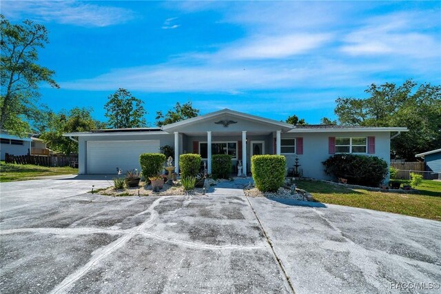 66 S Desoto St, Beverly Hills, FL 34465 - ranch-style home featuring a garage, driveway, a porch, and stucco siding