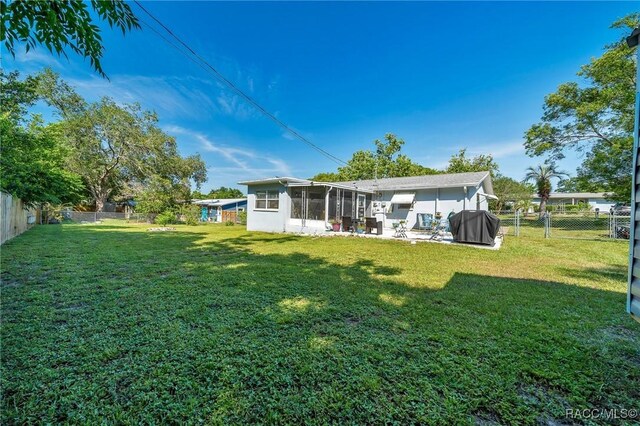 66 S Desoto St, Beverly Hills, FL 34465 - back of property with a sunroom and a patio area