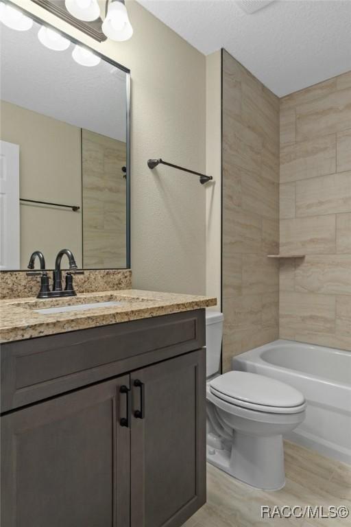 977 W Homeway Loop, Citrus Springs, FL 34434 - bathroom with vanity, wood finished floors, and tub / shower combination