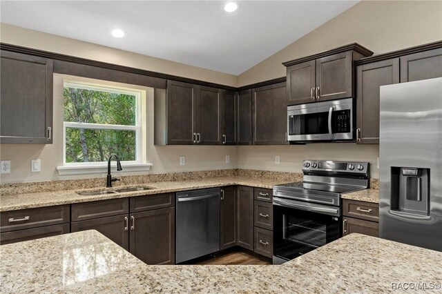 977 W Homeway Loop, Citrus Springs, FL 34434 - kitchen with stainless steel appliances, lofted ceiling, dark brown cabinetry, light stone countertops, and recessed lighting