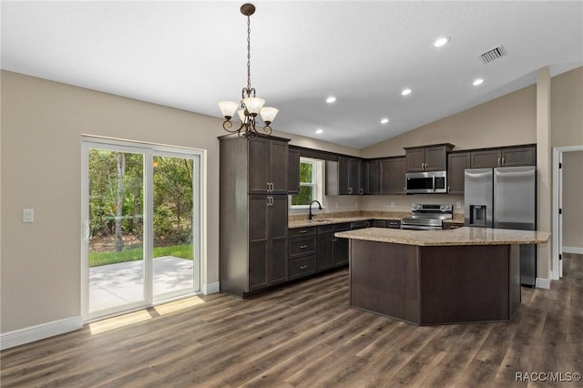 977 W Homeway Loop, Citrus Springs, FL 34434 - kitchen with appliances with stainless steel finishes, a kitchen island, dark wood-type flooring, a chandelier, and lofted ceiling