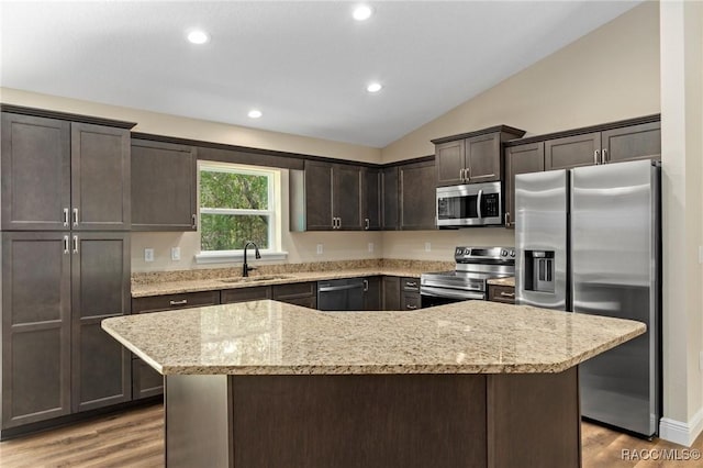977 W Homeway Loop, Citrus Springs, FL 34434 - kitchen featuring appliances with stainless steel finishes, dark brown cabinets, vaulted ceiling, light wood-style floors, and recessed lighting