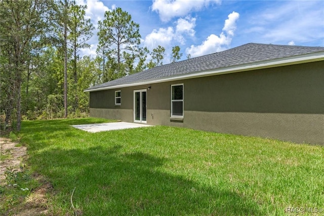 977 W Homeway Loop, Citrus Springs, FL 34434 - rear view of house with a patio area, stucco siding, a lawn, and roof with shingles