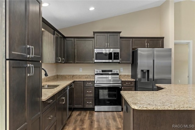 977 W Homeway Loop, Citrus Springs, FL 34434 - kitchen with appliances with stainless steel finishes, lofted ceiling, dark brown cabinetry, dark wood-type flooring, and recessed lighting