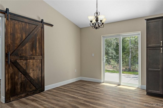 977 W Homeway Loop, Citrus Springs, FL 34434 - unfurnished dining area with a chandelier, wood finished floors, and a barn door