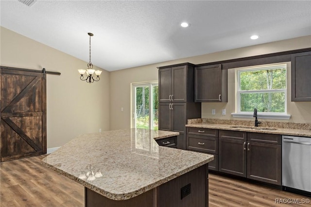 977 W Homeway Loop, Citrus Springs, FL 34434 - kitchen featuring dishwasher, lofted ceiling, wood finished floors, a kitchen island, and dark brown cabinets