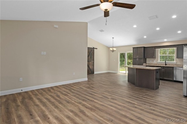 977 W Homeway Loop, Citrus Springs, FL 34434 - kitchen with a barn door, a kitchen island, stainless steel dishwasher, open floor plan, and dark wood-type flooring