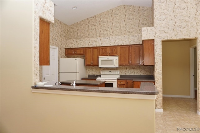 kitchen with kitchen peninsula, lofted ceiling, light tile patterned flooring, and white appliances