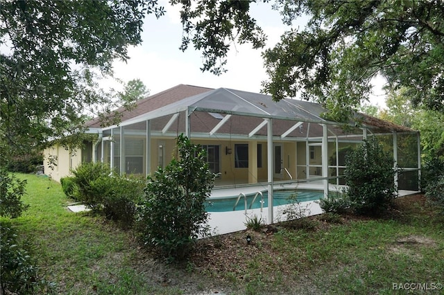 back of property featuring a lanai