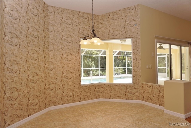 unfurnished dining area with tile patterned floors, ceiling fan, and a healthy amount of sunlight