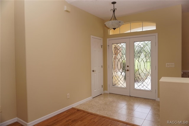 entrance foyer with light hardwood / wood-style flooring and french doors