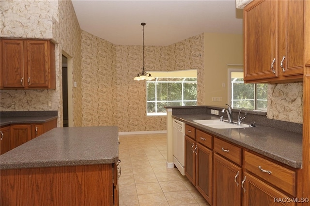 kitchen with sink, decorative light fixtures, dishwasher, a kitchen island, and light tile patterned flooring