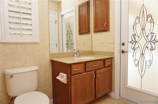 bathroom featuring tile patterned floors, vanity, and toilet