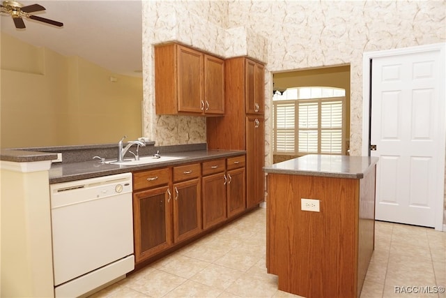 kitchen with ceiling fan, sink, a kitchen island, white dishwasher, and light tile patterned floors