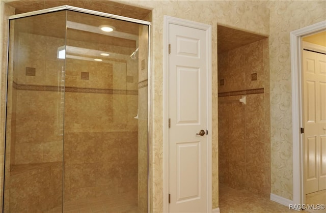 bathroom with a shower with door