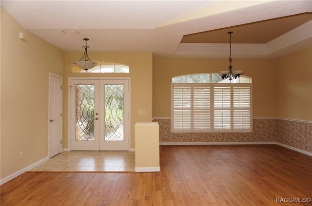 entryway with hardwood / wood-style floors, a wealth of natural light, and french doors