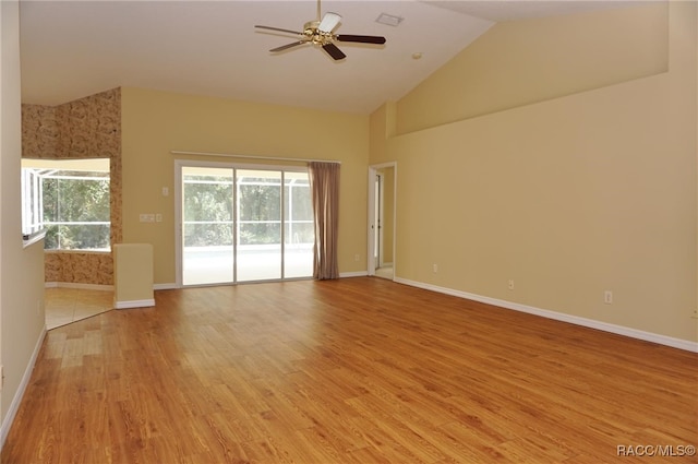 spare room featuring ceiling fan, light hardwood / wood-style floors, and vaulted ceiling