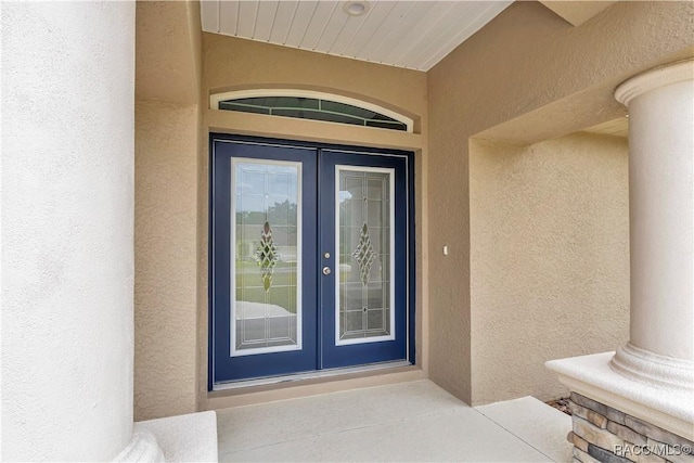 5443 N Nakoma Dr, Beverly Hills, FL 34465 - view of exterior entry featuring french doors and stucco siding