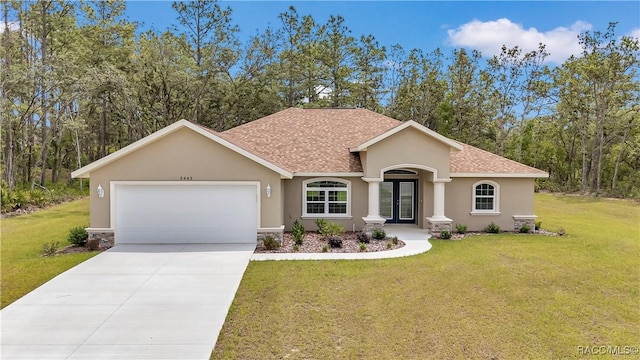 5443 N Nakoma Dr, Beverly Hills, FL 34465 - mediterranean / spanish-style house with an attached garage, stucco siding, a shingled roof, and french doors