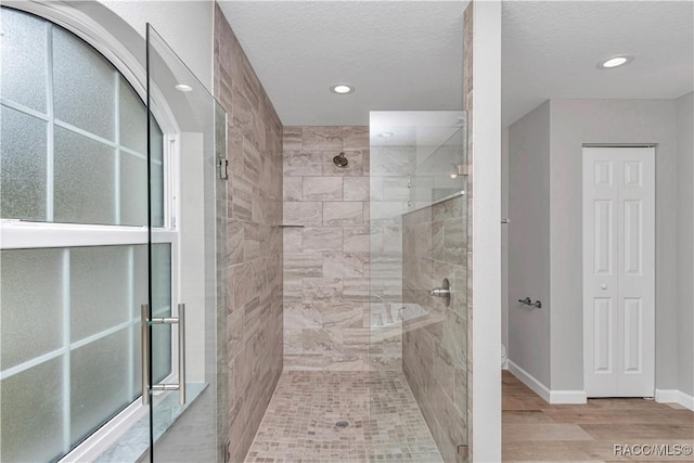 5443 N Nakoma Dr, Beverly Hills, FL 34465 - bathroom featuring a stall shower, wood finished floors, recessed lighting, and a textured ceiling