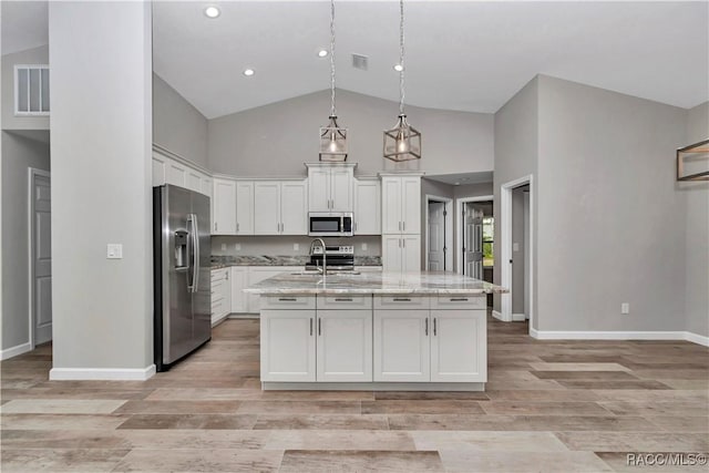 5443 N Nakoma Dr, Beverly Hills, FL 34465 - kitchen featuring appliances with stainless steel finishes, high vaulted ceiling, white cabinetry, light wood finished floors, and light stone counters