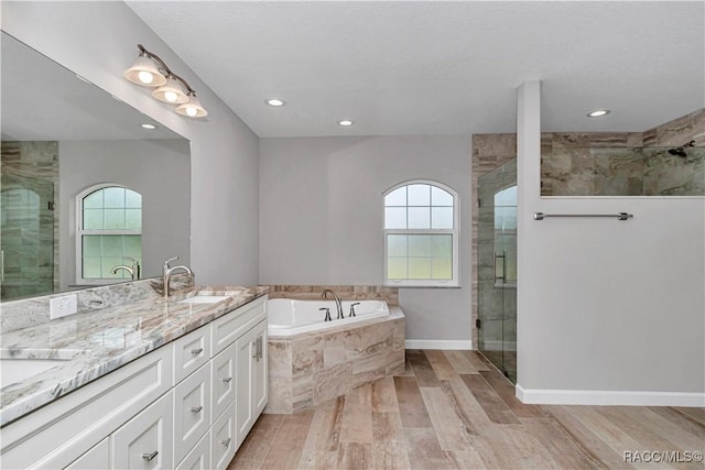 5443 N Nakoma Dr, Beverly Hills, FL 34465 - bathroom featuring healthy amount of natural light, a stall shower, a garden tub, double vanity, and recessed lighting