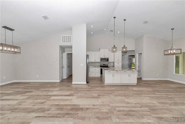 5443 N Nakoma Dr, Beverly Hills, FL 34465 - kitchen featuring appliances with stainless steel finishes, open floor plan, a chandelier, white cabinetry, and hanging light fixtures
