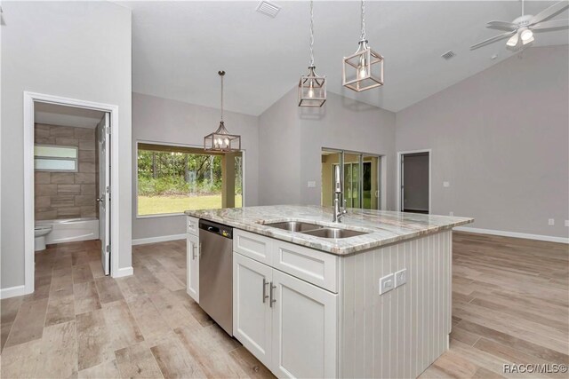 5443 N Nakoma Dr, Beverly Hills, FL 34465 - kitchen featuring dishwasher, white cabinetry, an island with sink, decorative light fixtures, and light wood-type flooring