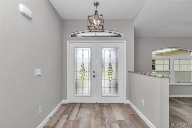 5443 N Nakoma Dr, Beverly Hills, FL 34465 - entrance foyer featuring a chandelier, wood finished floors, and french doors